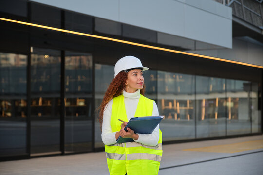 Latin female architect working on urban project in city