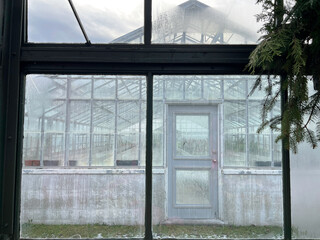 condensation on windows and doors of an empty greenhouse in winter