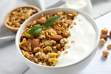 Delicious granola with yogurt on a light background