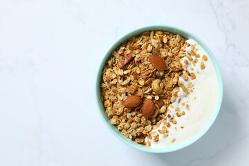 Delicious granola with yogurt on a light background