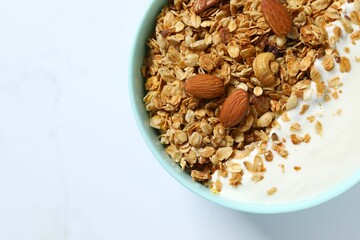 Delicious granola with yogurt on a light background