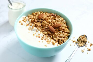 Delicious granola with yogurt on a light background