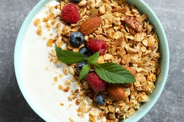Delicious granola with berries and yogurt on a light background