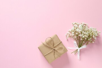 Top view photo with gift box and gypsophila flowers on color background 