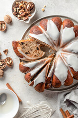 Christmas glazed gingerbread cake sliced on white table with spices. Christmas festive dessert, homemade holiday baking recipe. Top view