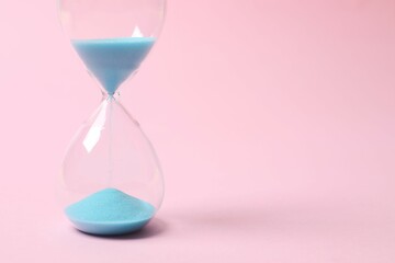 Modern hourglass on color background. Hourglass time concept for business deadline, urgency and...