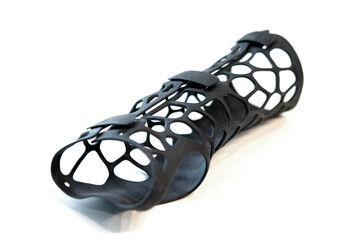Hand splint corset prosthesis printed on 3D printer from molten black plastic powder isolated on...
