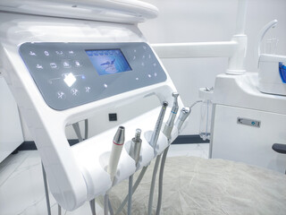 Patient chair used by  professionals for treatment and tools used by doctors in dental procedures. Dental treatment instruments and dental clinic. dental hospital and clinic  © UniqDream