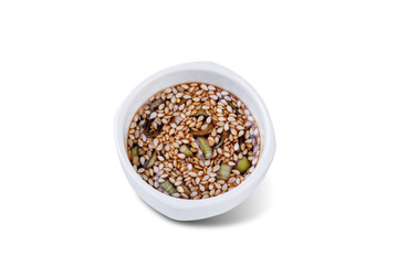 Spicy sesame seeds scallion soy sauce in a white bowl on a white isolated background
