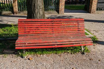 red bench, in an avenue of a park in Venice, in many Italian cities today it has become a symbol in memory of violence against women and prevention and awareness against gender violence and femicide.