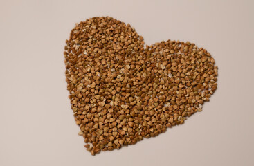 A delicate buckwheat heart is depicted on a plain white surface.