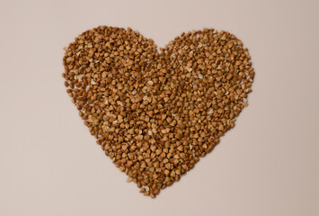 A heart crafted from buckwheat rests on a pristine white background