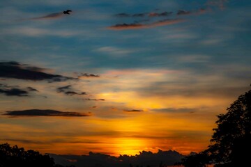 Fototapeta premium Sunrise with intense natural orange lights and idyllic dramatic scenery