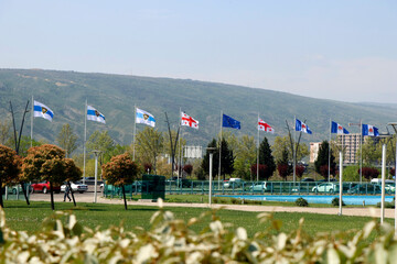 georgian flag, european union flag and police patrol flag all in a row at tbilisi
