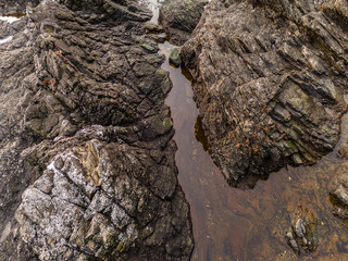 Rocky Coastal Terrain with Small Pools and Mossy Stone Features