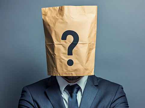 Individual in a suit with a paper bag on their head symbolizing anonymity in a corporate environment - Powered by Adobe