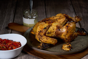 Whole chicken rotisory grilled with pickled peppers and garlic sauce
