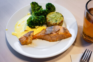 Tasty fish dish - salmon steak served with broccoli and baked potato