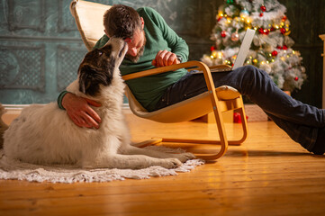 man with dog   with laptop during the Christmas