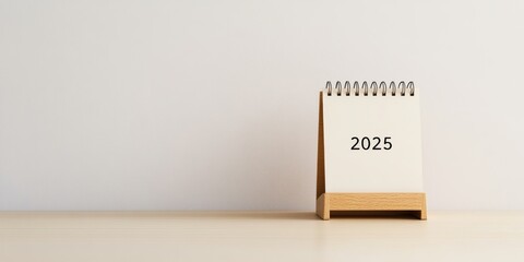 Minimalist spiral desk calendar with a wooden stand and clean design for the year 2025
