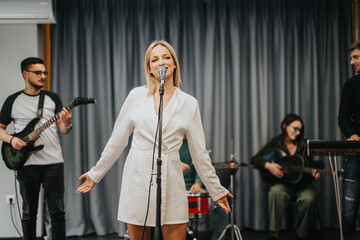 A dynamic band performance featuring a female singer with musicians playing instruments live on...