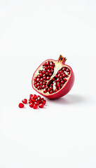 Sliced Pomegranate with Juicy Red Seeds Scattered on White Surface