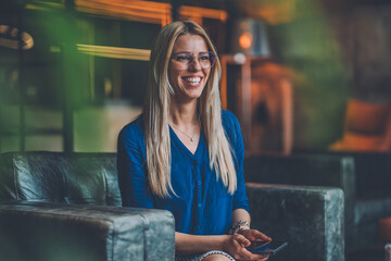 Beautiful Female Blogger Holding Her Phone and Smiling Widely