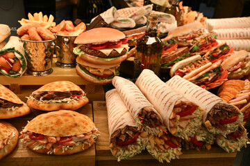 Mouth-watering meat and vegetable rolls, salmon and ham sandwiches; nuggets in the cafe window