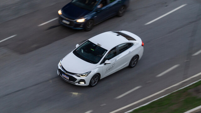 Panning shot of a white Chevrolet Cruze, Sedan in city highway, High Resolution