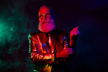 Photo of confident charismatic showman wear trendy clothes fasten cufflinks isolated on dark neon color background