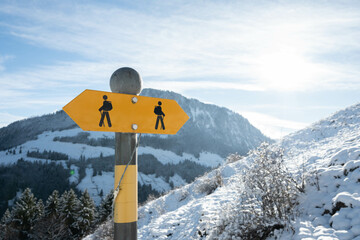 Hiking sign path in Swiss alps in snow