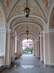 Fototapeta premium beautiful view of tree through beautiful arch of opera house building with columns and lamps muzik
