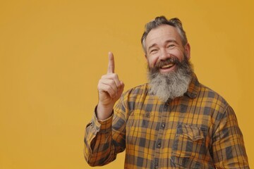 Fototapeta premium Happy middle aged man with beard pointing to side.
