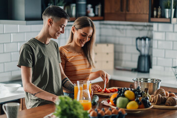 Lesbian couple preparing healthy breakfast in modern kitchen