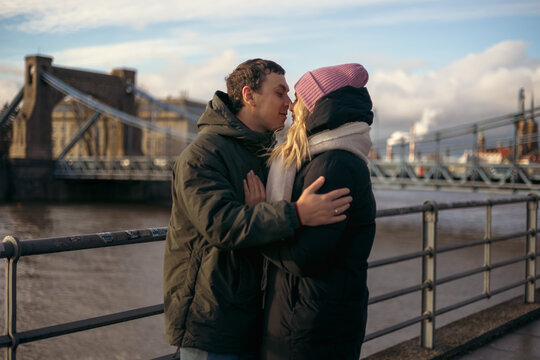 Young couple embracing by the river in Wroclaw, Poland