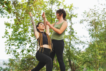 Joyful transgender couple practicing yoga outdoors