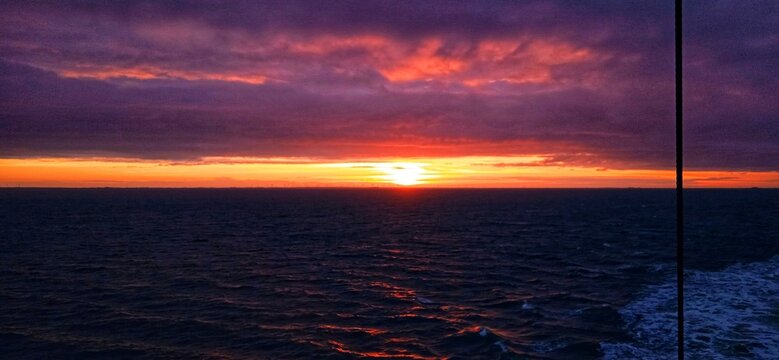 Sonnenaufgang &uuml;ber der Nordsee mit roten Wolken