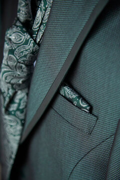 Elegant details of a suit with paisley tie and pocket square