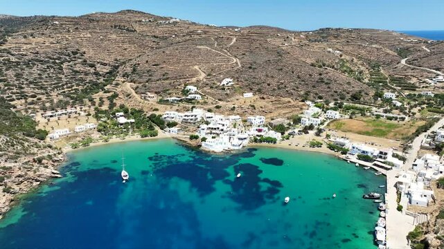 Aerial drone cinematic video of famous and picturesque seaside fishing village and beach of Faros, featuring beaches of Fasolou and Vlycho, Sifnos island, Cyclades, Greece