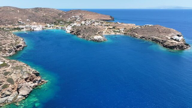 Aerial drone cinematic video of famous and picturesque seaside fishing village and beach of Faros, featuring beaches of Fasolou and Vlycho, Sifnos island, Cyclades, Greece