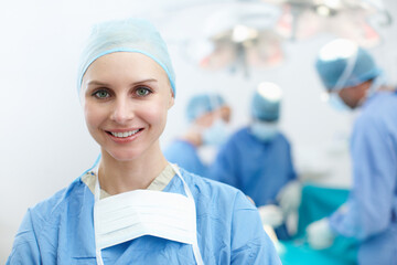 Woman, smile or surgeon in portrait for surgery, emergency accident or healthcare in hospital...