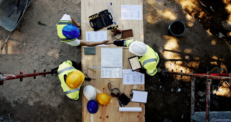 Blueprint, construction site and men at table with handshake, collaboration and agreement from...