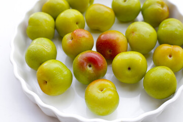 Fresh green plum on white background