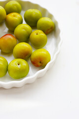 Fresh green plum on white background
