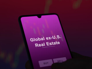 An investor analyzing the global ex-u.s. real estate etf fund on a screen. A phone shows the prices...