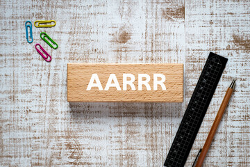 There is wood block with the word AARRR. It is an abbreviation for Acquisition, Activation,...