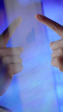 Hands Directing Attention Towards a Financial Chart Displayed on a Digital Screen Surface