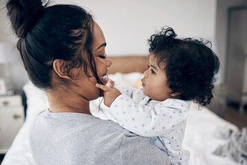 Love, mother and bonding with baby in home for protection, child development and morning routine. Parenting, woman and carrying infant in bedroom with smile, support and relationship with connection