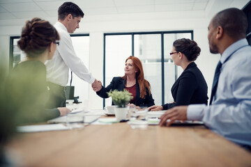 Business people, handshake and success for deal with welcome, agreement and diversity in office. Women, men and teamwork as thank you for onboarding, partnership or negotiation in meeting for company