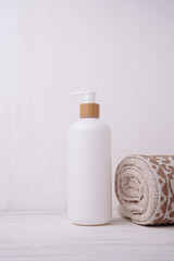 Cosmetic bottle mockup, on a beige background, hand holding the bottle, mockup for branding your product